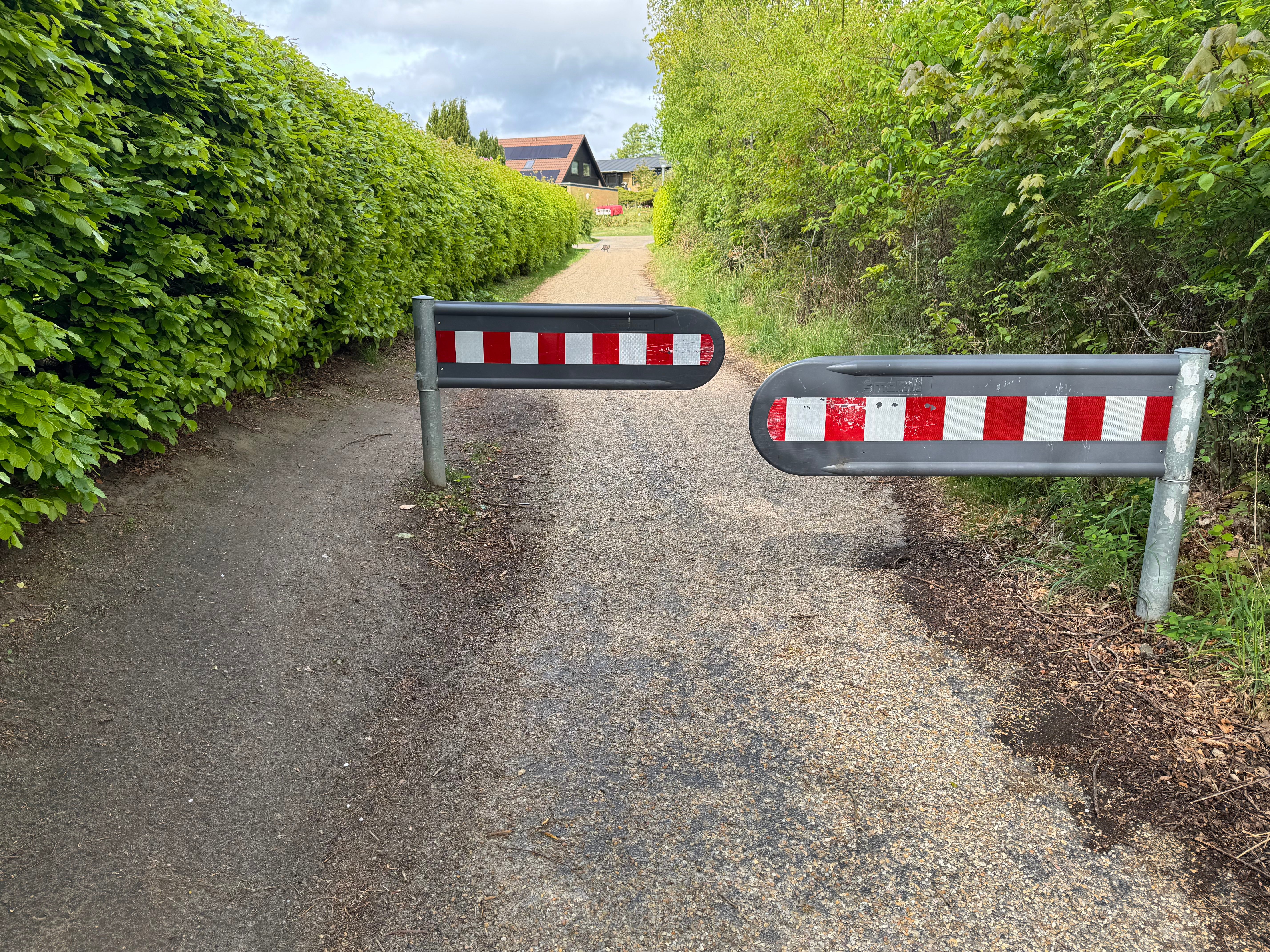 Bom 2 midt på cykelstien set mod nord. Samme konstruktion som Bom 1: to selvlukkende spærrebomme med rød-hvid plastkappe